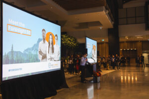 Corporate conference with stage lighting, large format projection, and professional sound reinforcement